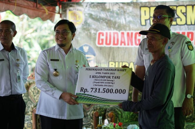 
 Bupati Aulai menyerahkan hibah kepada kelompok tani usai meresmikan gudang penampungan lump di Limbar BAS, Rabu (15/3/2023).